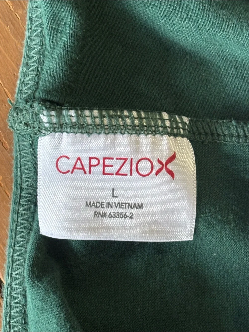 Capezio forest green camisole leotard with a v-neckline and princess seams.